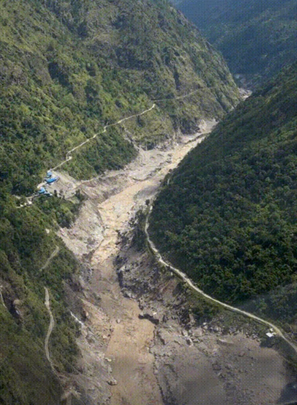 Steep canyon walls channeled the flood’s rush of water, mud and rock through the Nepal–Tibet border region in August 2026.